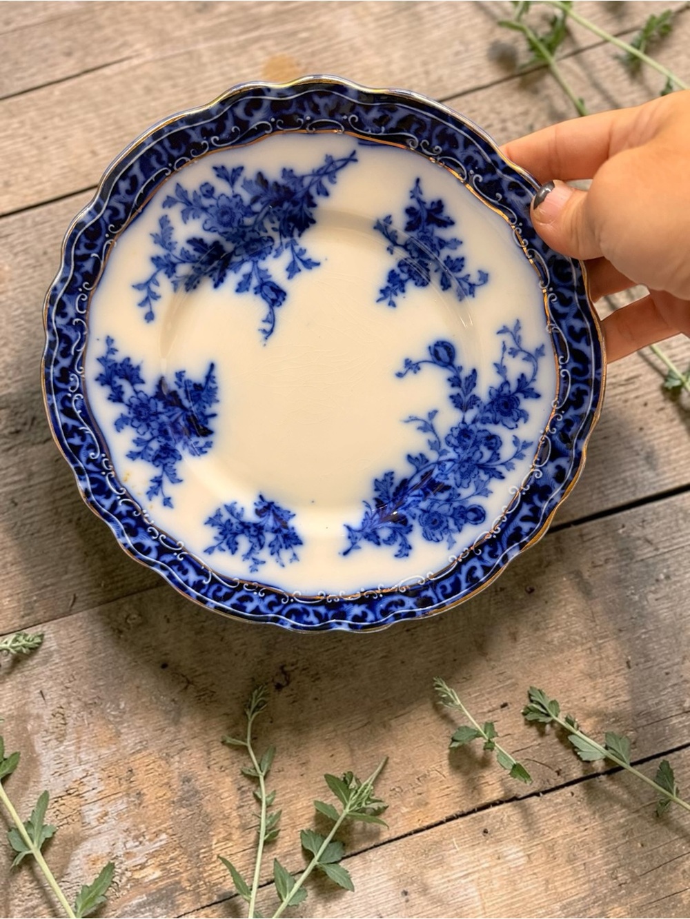 A flow blue porcelain plate with floral transferware by Stanley Pottery.